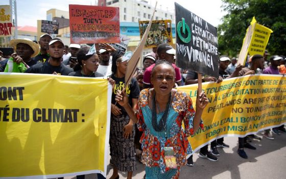 A woman leads environmental activists in a climate protest in Kinshasa, Congo, in November 2019. As they mark the Season of Creation, Catholics in Africa celebrate the Congo Basin as the second "lung" of the Earth. (CNS photo/Hereward Holland, Reuters)