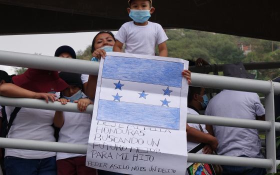 A Honduran boy and his mother are seen prior to the start of the "Restore Protections for Holy Families: Prophetic Action to #SaveAsylum" demonstration in Nogales, Mexico, Sept. 25, 2021. (CNS photo/courtesy Ignatian Solidarity Network)