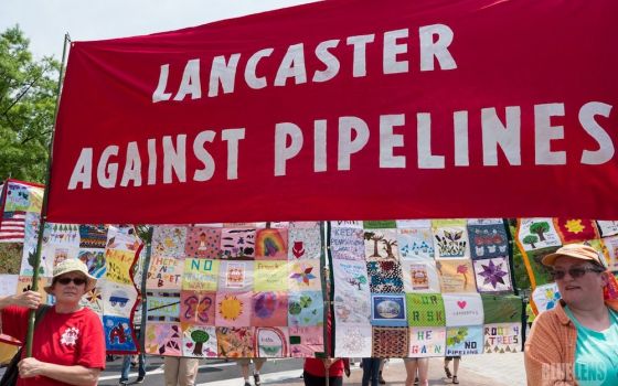 Activists with Lancaster Against Pipelines carry a banner during a 2017 climate march in Washington. A federal court judge has dismissed a lawsuit filed by the Adorers of the Blood of Christ, a religious order that has been challenging construction of a n
