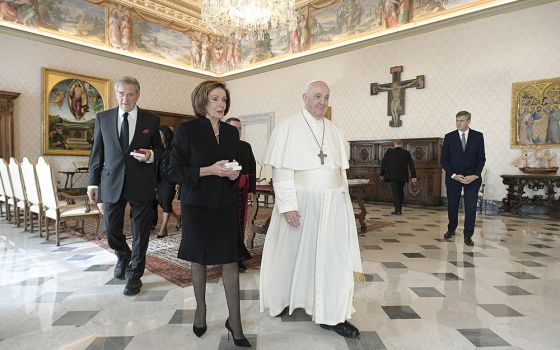 Pope Francis walks with U.S. House Speaker Nancy Pelosi, D-California, accompanied by her husband, Paul, during a private audience Oct. 9, 2021, at the Vatican. (CNS/Vatican Media)