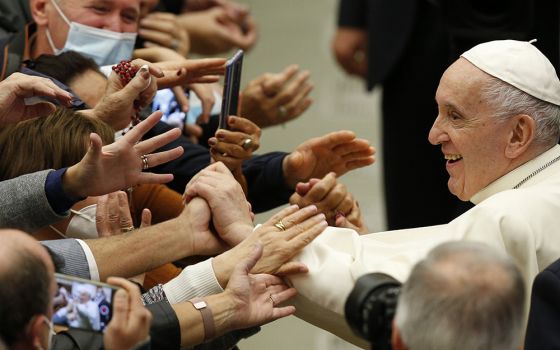 Pope Francis greets people during his general audience in the Paul VI hall Oct. 13 at the Vatican. (CNS/Paul Haring)