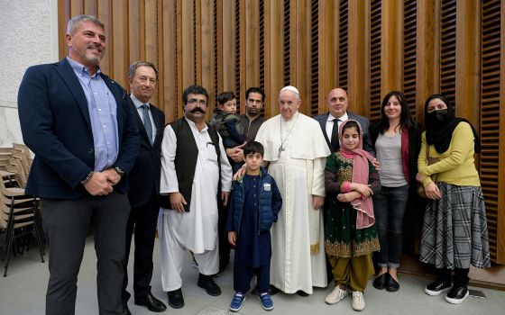 Pope Francis meets family members who fled from Afghanistan, during his general audience in the Paul VI hall at the Vatican Oct. 13, 2021. (CNS photo/Vatican Media)