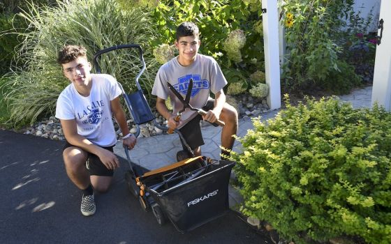 Business partners and twin brothers Brendan, left, and Patrick McNaughton, 16, started an environmentally friendly lawn care business in Albany, New York, called Zero Carbon Lawn Care. (CNS photo/Cindy Schultz, The Evangelist)