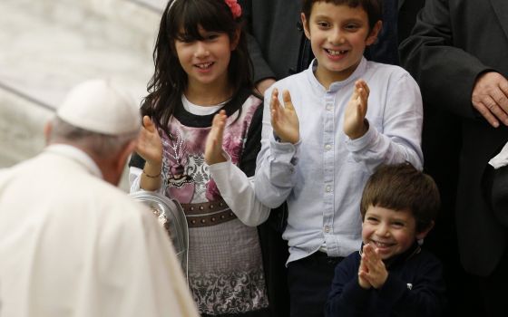 Children applaud as they meet Pope Francis during his general audience in the Paul VI hall at the Vatican Oct. 27, 2021. (CNS photo/Paul Haring)