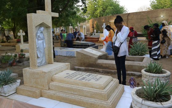 A family prays next to a relative's grave in a cemetery during All Souls' Day in Khartoum, Sudan, in this Nov. 11, 2014, file photo. (CNS photo/Mohamed Nureldin Abdallah, Reuters)