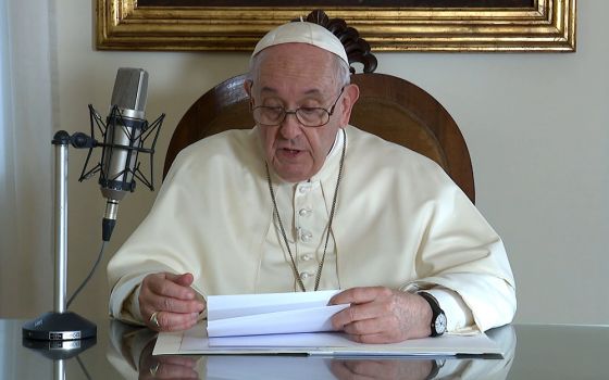 Pope Francis reads a message to listeners of BBC Radio Oct. 29, in this still image taken from video released by the Vatican. (CNS/Vatican Media)