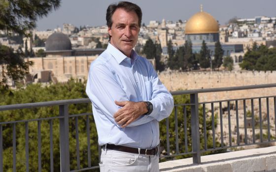 Bernard Thibaud, manager of Abraham's House, poses on the Mount of Olives overlooking Jerusalem Oct. 28, 2021. (CNS photo/Debbie Hill)
