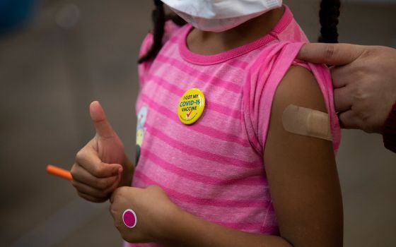 Josclyn Ledisma, 5, gives a thumbs up after receiving her first dose of the COVID-19 vaccine inside Mary's Center in Washington Nov. 3, 2021. (CNS photo/Tom Brenner, Reuters)