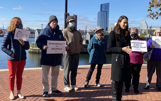 Sarah Pearson, in black coat, was part of a group of sex abuse survivors who called on U.S. bishops, in a Nov. 16 press conference in Baltimore, to focus less on who can take Communion and instead do more about sex abuse.