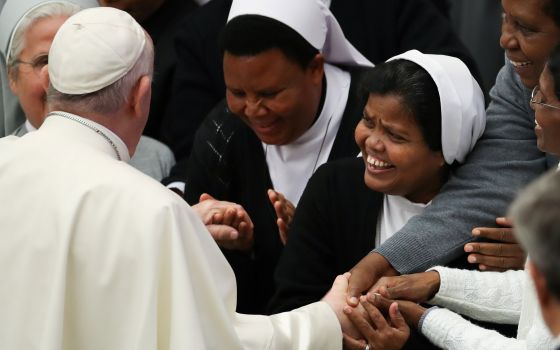 Pope Francis greets a group of nuns after his general audience in Paul VI hall at the Vatican Dec. 1, 2021. (CNS photo/Yara Nardi, Reuters)