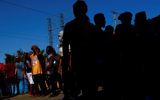 Migrants from Haiti heading to the U.S. border block a road in Huehuetán, Mexico, Nov. 30, 2021. (CNS photo/Jose Luis Gonzalez, Reuters)