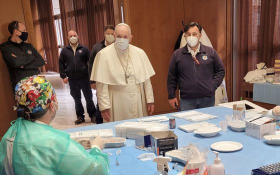 Pope Francis visits a COVID-19 vaccination clinic in the Paul VI hall April 2 at the Vatican. Throughout the year, the pope continued to encourage vaccination against COVID-19. (CNS/Holy See Press Office)