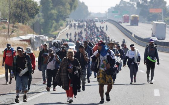 Migrants walk on a highway in San Martín Texmelucan de Labastida, Mexico, Dec. 10, 2021, as they head to Mexico City to apply for asylum and refugee status.  (CNS photo/Imelda Medina, Reuters)