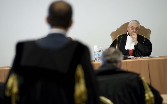 Vatican judge Giuseppe Pignatone listens during the third session of the trial of six defendants accused of financial crimes, at the Vatican City State criminal court in this Nov. 17, 2021. (CNS photo/Vatican Media)
