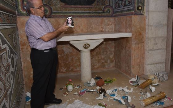 Salesian Father Antonio Scudu, caretaker of St. Stephen Church in the Beit Jamal Salesian monastery near Jerusalem, holds a portion of a shattered statue of Mary Sept. 26, 2017, after vandals broke into the church.  (CNS photo/Debbie Hill)
