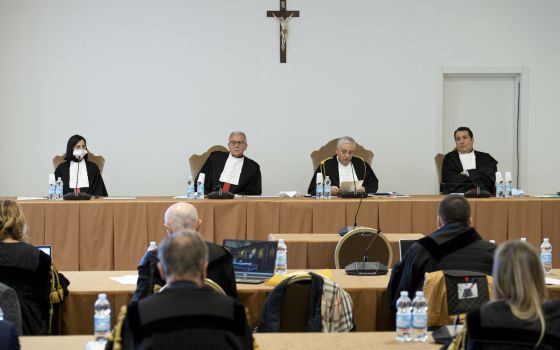 Vatican judges preside over the third session of the trial of six defendants accused of financial crimes, including Cardinal Angelo Becciu, at the Vatican City State criminal court in this Nov. 17, 2021. Pictured from left are judges Lucia Bozzi, Venerand