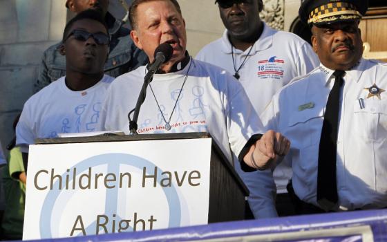 Fr. Michael Pfleger, senior pastor of the Faith Community of St. Sabina in Chicago, speaks at a June 17, 2016, rally to end gun violence. (CNS photo/Karen Callaway, Catholic New World)