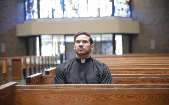 Deacon Jeremy Schupbach, a fourth-year seminarian who was assigned to St. Frances Cabrini Parish in Allen Park, Michigan, for the summer, sits in contemplation at the parish church July 27. (CNS/Detroit Catholic/Dan Meloy)