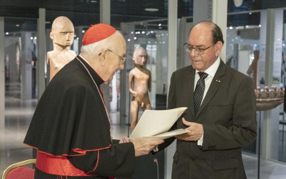 Cardinal Fernando Vérgez Alzaga, president of the Pontifical Commission for Vatican City State, and Peruvian Foreign Minister César Landa Arroyo exchange documents after signing an agreement Oct. 17, 2022, in the Vatican Museums to repatriate three mummies that have been in the Vatican collection since 1925. (CNS photo/Courtesy Vatican Museums)