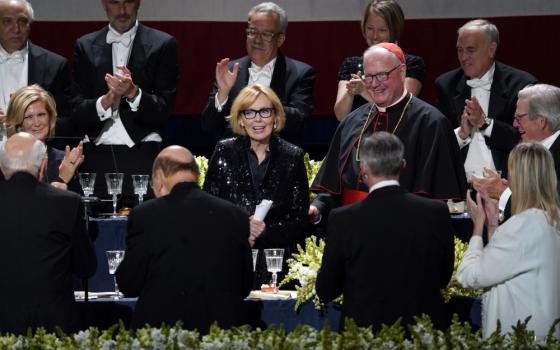 Peggy Noonan, Pulitzer Prize-winning Wall Street Journal columnist and former speech writer for President Ronald Reagan, is acknowledged by the audience, including New York Cardinal Timothy M. Dolan