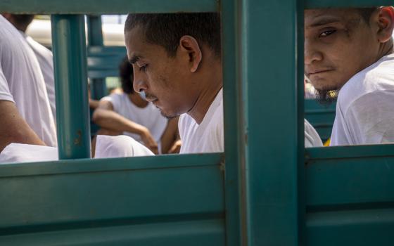 Men who were detained by the police are brought to a detention center in Soyapango, El Salvador, Oct. 12, during the "state of exception" the government has declared in a crackdown on gangs. (AP/Moises Castillo)