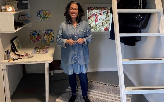 Melanie Rodriguez, a 51-year-old artist and former teacher, stands in her new tiny home at Kenton Women's Village.