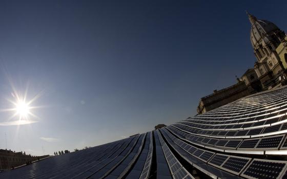 Solar panels are seen from the roof of the Paul VI audience hall at the Vatican in 2008. It was the first solar-generated electrical system installed at the Vatican. (CNS/Reuters/Tony Gentile)