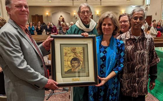 Maryknoll Lay Missioners Kirstin and Merwyn De Mello receive the 2022 Bishop John E. McCarthy Spirit of Mission Award during Mass at Holy Redeemer Church in Washington Oct. 23, 2022. Presenting the award were Ted Miles, left, executive director of Maryknoll Lay Missioners, and Mary Novak, second from right, who is executive director of Network, a Catholic social justice lobby. (CNS photo/Leroy Partlow, courtesy Maryknoll Lay Missioners)