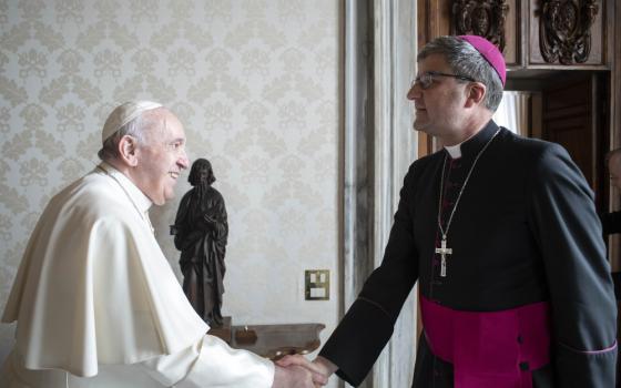 Pope Francis greets Archbishop Éric de Moulins-Beaufort of Reims, president of the French bishops' conference, during a meeting at the Vatican Dec. 13, 2021. 