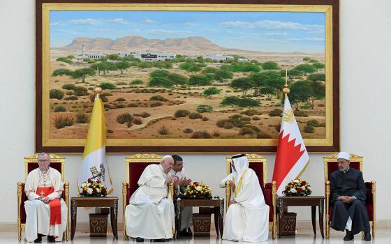 Pope Francis and Bahrain’s King Hamad bin Isa Al Khalifa speak at a farewell ceremony for the pope Nov. 6 at Sakhir air base in Awali. Also pictured is Cardinal Pietro Parolin, Vatican secretary of state, and Sheikh Ahmad el-Tayeb, grand imam of Egypt's Al-Azhar mosque and university. (CNS/Vatican Media via Reuters)