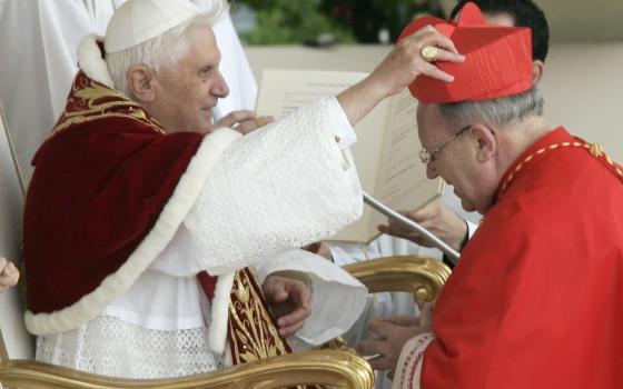 French Cardinal Jean-Pierre Ricard of Bordeaux receives his red hat from then-Pope Benedict XVI during his induction into the College of Cardinals at the Vatican March 24, 2006. The cardinal has admitted to abusing a 14-year-old girl 35 years ago. (CNS photo/Tony Gentile, Reuters)