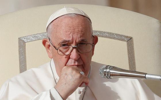 Pope Francis rests his hand on his chin