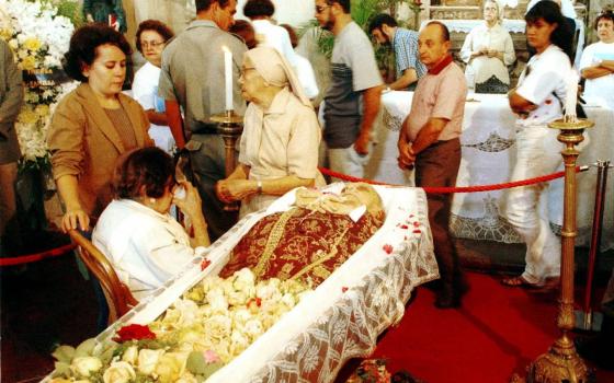 Mourners walk past the casket of Archbishop Hélder Câmara in Recife, Brazil, Aug. 28, 1999. 