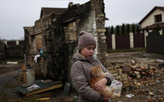 Yuliia Zaika, a 9-year old Ukrainian girl, holds her cat in the village of Moshchun near Kyiv, Ukraine, Nov. 8, 2022.