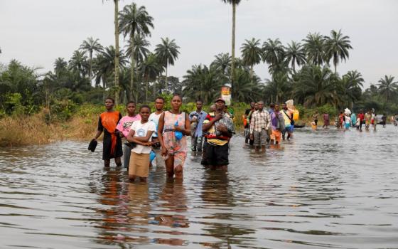 Residents wade through floodwaters in Obagi, Nigeria, Oct. 21, 2022. (CNS/Reuters/Temilade Adelaja)
