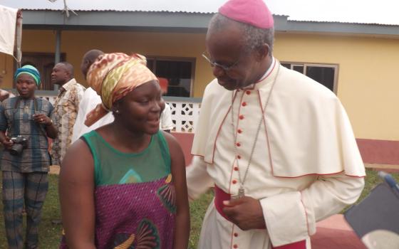 Cardinal Baawobr speaks with a woman