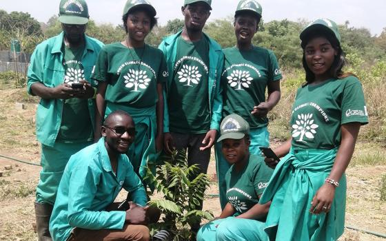 Climate Youth Champions, supported by Catholic Relief Services, plant trees and advocate for a move away from charcoal burning, which is worsening deforestation in Zambia. (Tawanda Karombo)