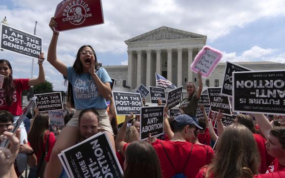 Anti-abortion protesters celebrate outside the Supreme Court in Washington June 24 in the wake of the court's decision in Dobbs v. Jackson Women's Health Organization. (RNS/AP/Jose Luis Magana)