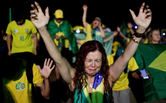 A supporter of Brazil's president and presidential candidate, Jair Bolsonaro, cries after former President Luiz Inacio Lula da Silva was proclaimed the winner of the presidential runoff, in Brasilia, Brazil, Oct. 30. (CNS/Reuters/Ueslei Marcelino)