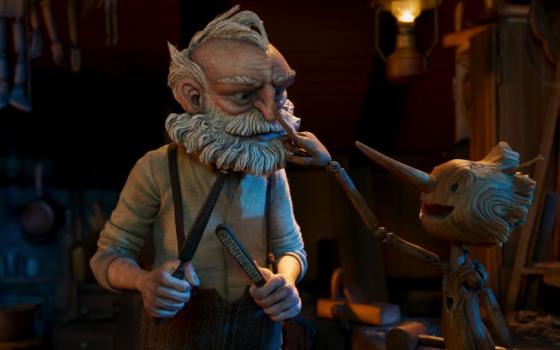 Gepetto (voiced by David Bradley) and Pinocchio (voiced by Gregory Mann) interact in a scene from "Guillermo del Toro's Pinocchio." (Netflix © 2022)