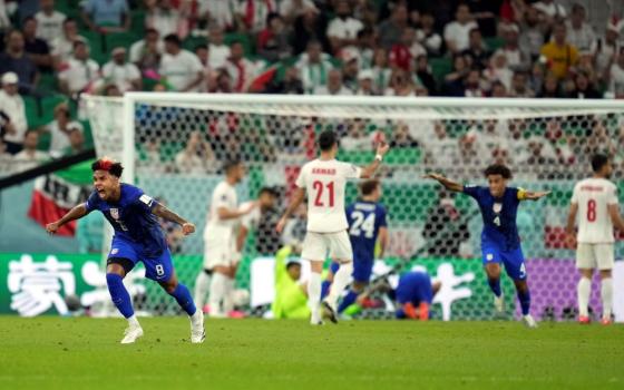 United States' Weston McKennie (8) celebrates after teammate Christian Pulisic scoring a goal during the World Cup group B soccer match between Iran and the United States at the Al Thumama Stadium in Doha, Qatar, Nov. 29. (AP/Ashley Landis)