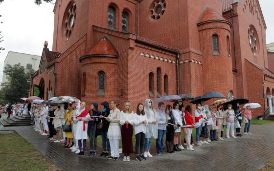 Women form a human chain in front of Sts. Simon and Helena Church in Minsk, Belarus, Aug. 27, 2020, during a protest against presidential election results. (CNS/Reuters/Vasily Fedosenko)