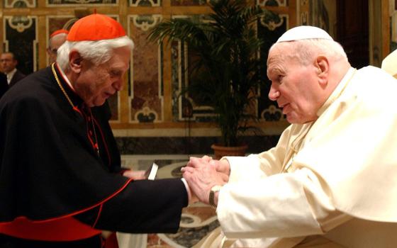 Cardinal Joseph Ratzinger, who later became Pope Benedict XVI, greets Pope John Paul II during a ceremony at the Vatican in this Feb. 6, 2004, file photo. (CNS/Catholic Press photo) 