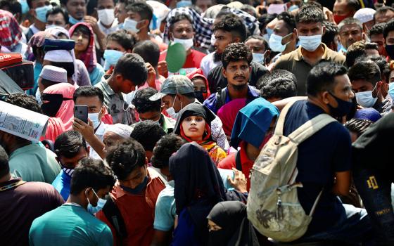 Migrants wait to board an overcrowded ferry to get home to celebrate Eid al-Fitr in Munshiganj, Bangladesh, May 10, 2021, after restrictions on public transportation were relaxed during the COVID-19 pandemic. (CNS/Reuters/Mohammad Ponir Hossain)