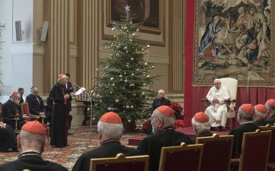 Cardinal Giovanni Battista Re, dean of the College of Cardinals, offers Pope Francis best wishes for Christmas on behalf of the cardinals and top officials of the Roman Curia during an audience in the Apostolic Palace at the Vatican Dec. 23, 2021. (CNS photo/Vatican Media)