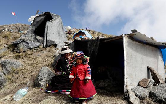 A woman from the Indigenous community of Huancuire and her daughter camp with others near the Las Bambas copper mine in Apurimac, Peru May 9, 2022. It was part of a protest to demand that their ancestral lands be returned to the communities. (CNS/Reuters/Angela Ponce)