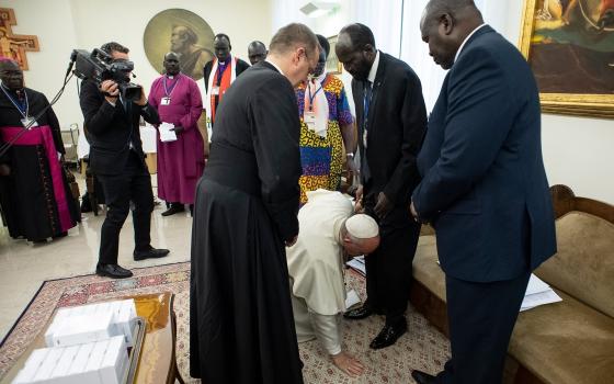 In this April 11, 2019 file photo, Pope Francis kneels at the feet of South Sudan President Salva Kiir at the conclusion of a two-day retreat for the African nation's political leaders, at the Vatican. This event was referenced at an international conference on nonviolence and the teaching of Pope Francis, held Dec. 5-7 in Rome. (CNS/Vatican Media via Reuters)