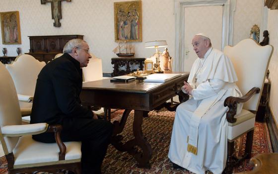 Pope Francis greets Jesuit Fr. Marko Rupnik during a private audience at the Vatican in this Jan. 3, 2022, file photo. Rupnik, whose mosaics decorate chapels in the Vatican, all over Europe, in the United States and Australia, is under restricted ministry after being accused of abusing adult nuns in Slovenia. (CNS/Vatican Media)
