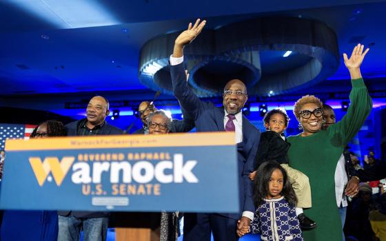 Sen. Raphael Warnock, D-Georgia, is joined on stage by family members during an election night party in Atlanta Dec. 6, after his projected win in the Georgia midterm runoff election over Republican challenger Herschel Walker. (CNS/Reuters/Carlos Barria)