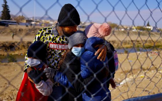 A family of Colombian migrants hug one another upon arriving at the U.S. border in El Paso, Texas, Dec. 19, 2022, to request asylum in the United States. (CNS photo/Jose Luis Gonzalez, Reuters)